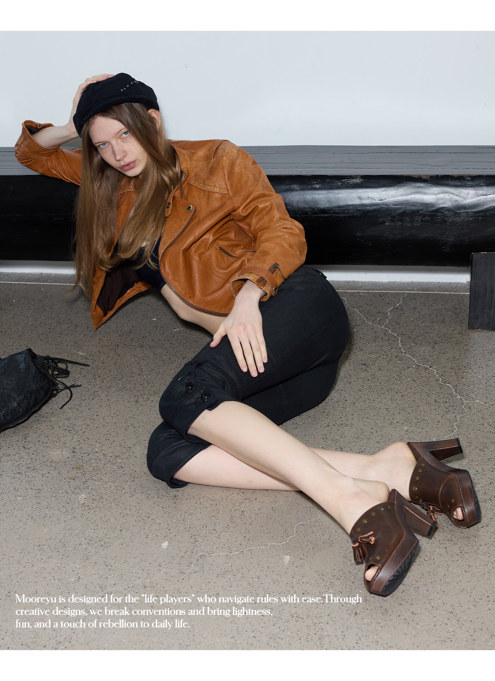 Full-length model shot in white tube top & cropped jeans, holding black fringe bag, wearing vintage brown leather platform mule clogs