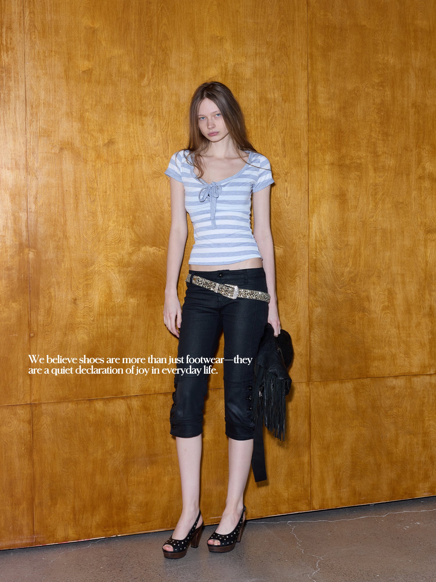 Full length shot of female model in stripe tie top & black capri pants, styled with black silver stud leather slingback peep toe wood block heel sandals