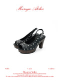White background studio shot of MOOREYU ATELIER punk black full grain leather slingback sandals, peep toe silver round studs, 10cm faux wood grain platform block heels