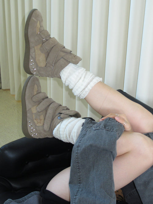 Close shot of woman’s feet in MOOREYU beige horsehair pointed slingback heels, indoor minimalist scene
