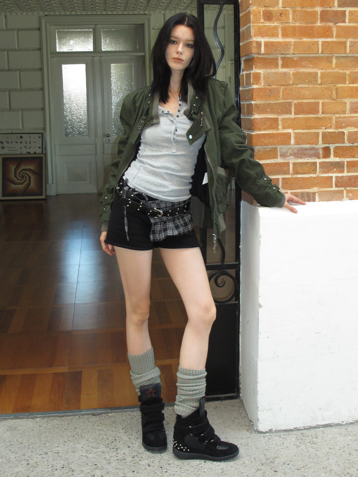 Female model wearing cream spotted horsehair slingback stiletto pumps, matching vintage punk street outfit