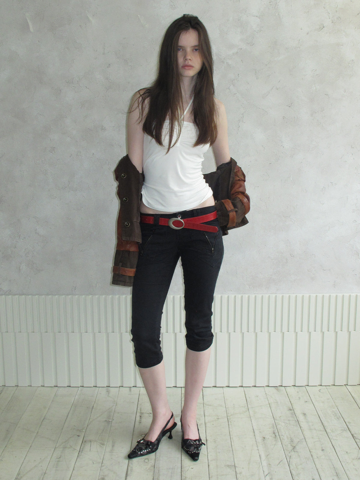 Female model wearing cream spotted horsehair slingback stiletto pumps, matching vintage punk street outfit