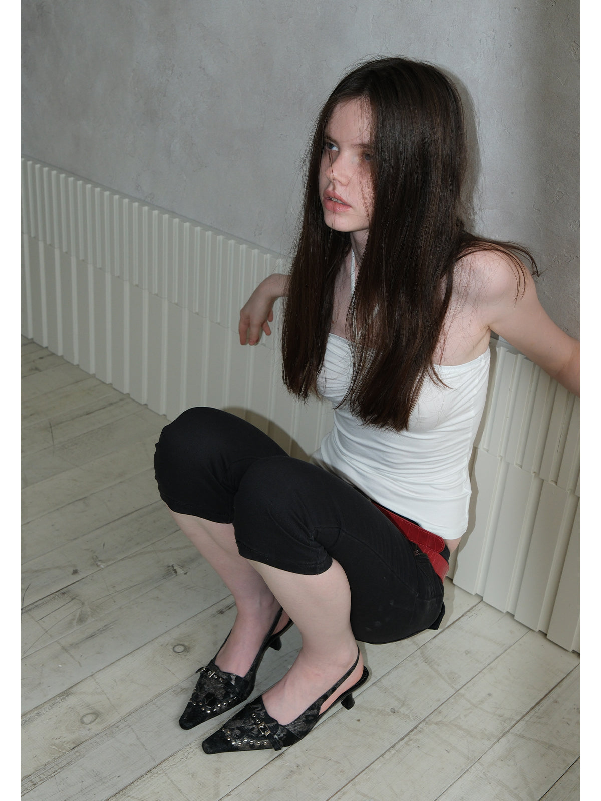 Female model wearing cream spotted horsehair slingback stiletto pumps, matching vintage punk street outfit
